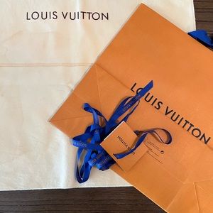 Louis Vuitton shopping bag, ribbon, gift card and dust bag.
